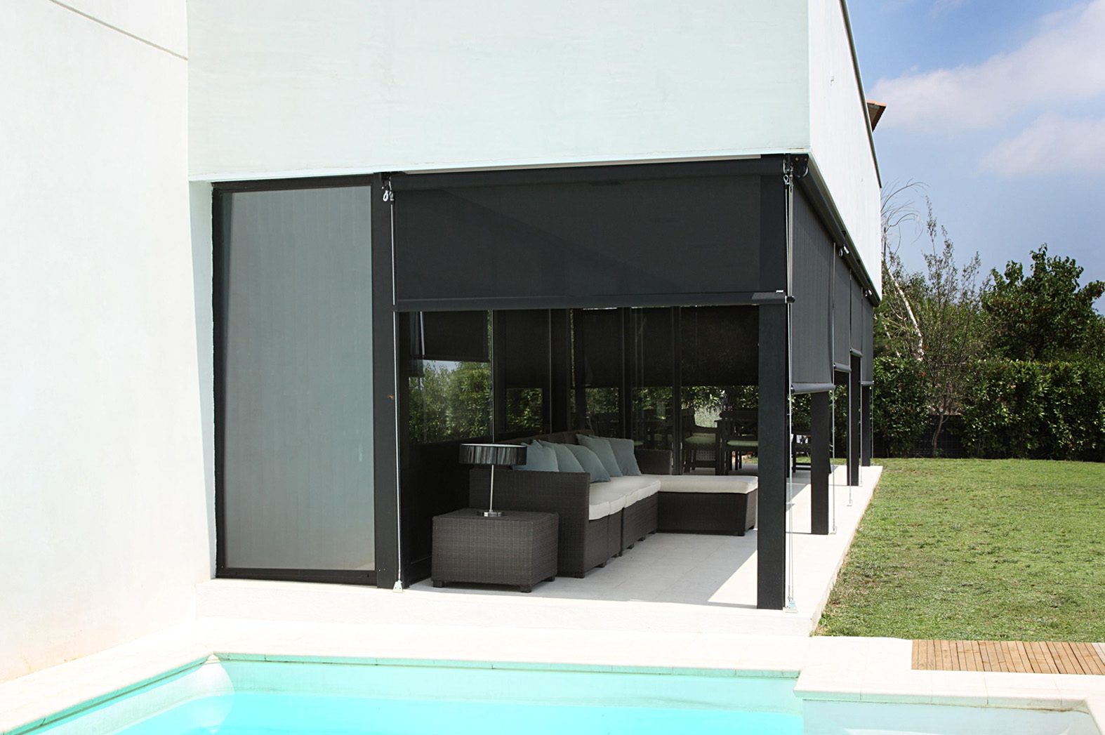 Exterior screen system shading a contemporary poolside patio
